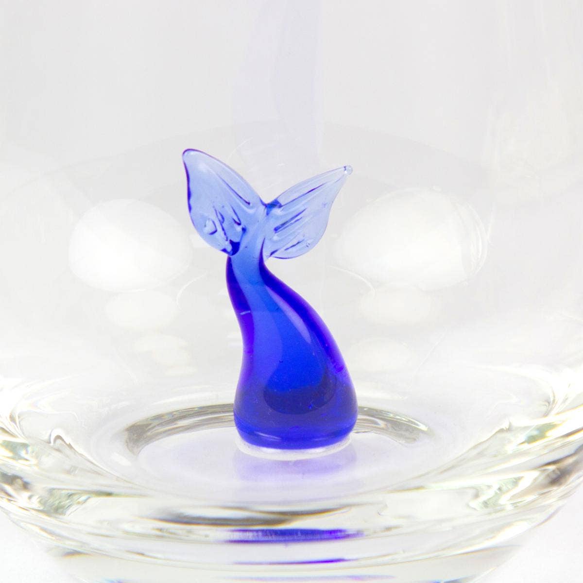 Drinking glass with a small glass whale tail