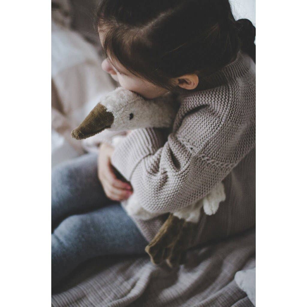 Small hot water bottle in the shape of a cuddly white goose