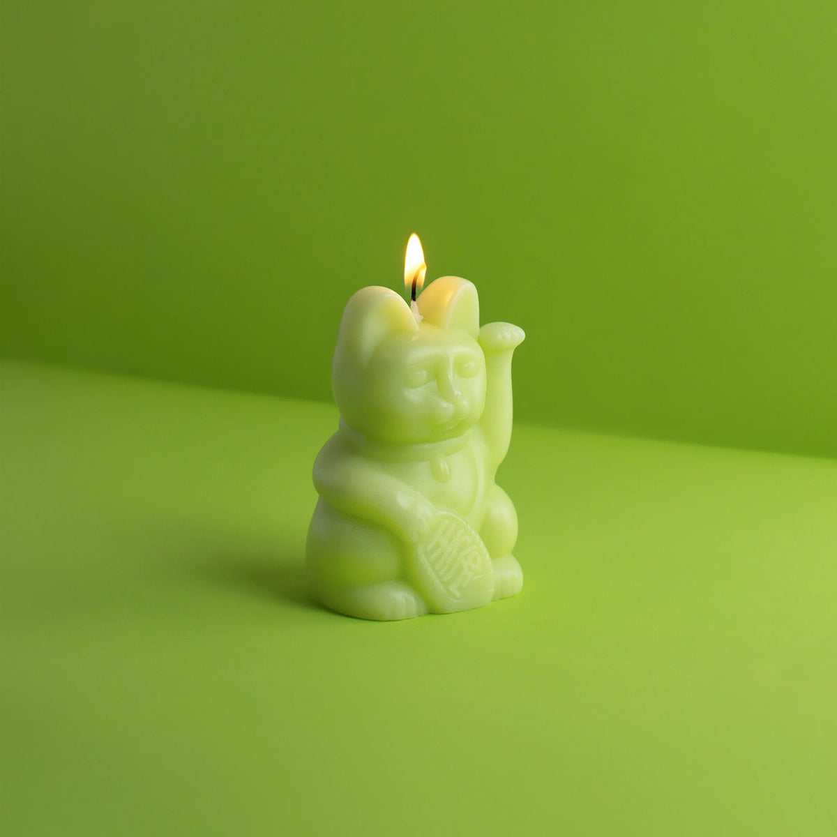 Candela portafortuna verde chiaro a forma di gatto