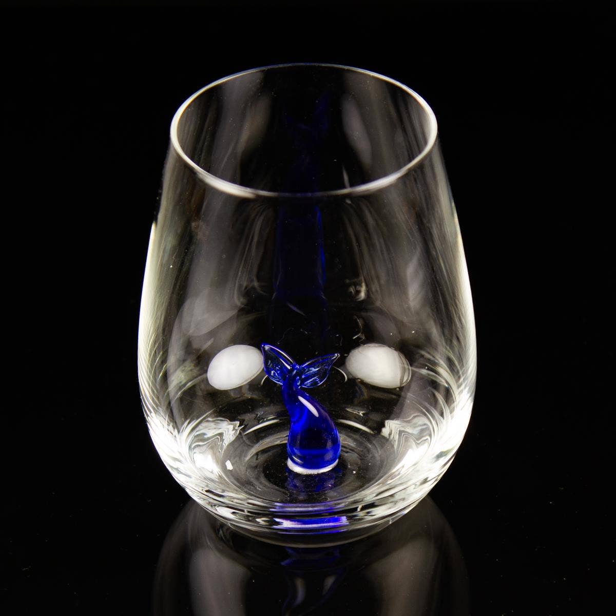 Drinking glass with a small glass whale tail