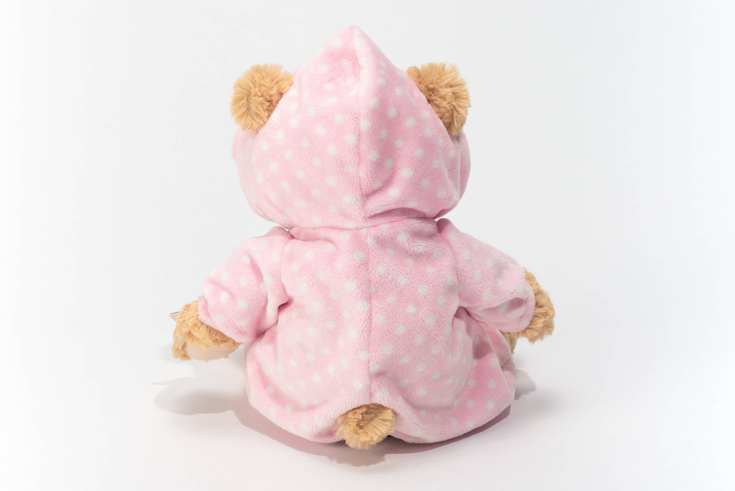 Plush teddy bear in pink pajamas