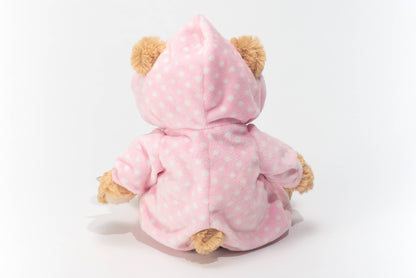 Plush teddy bear in pink pajamas