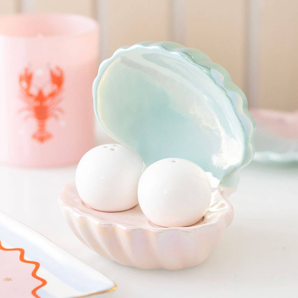 Salt and pepper egg cups in the shape of an iridescent coastal clam shell