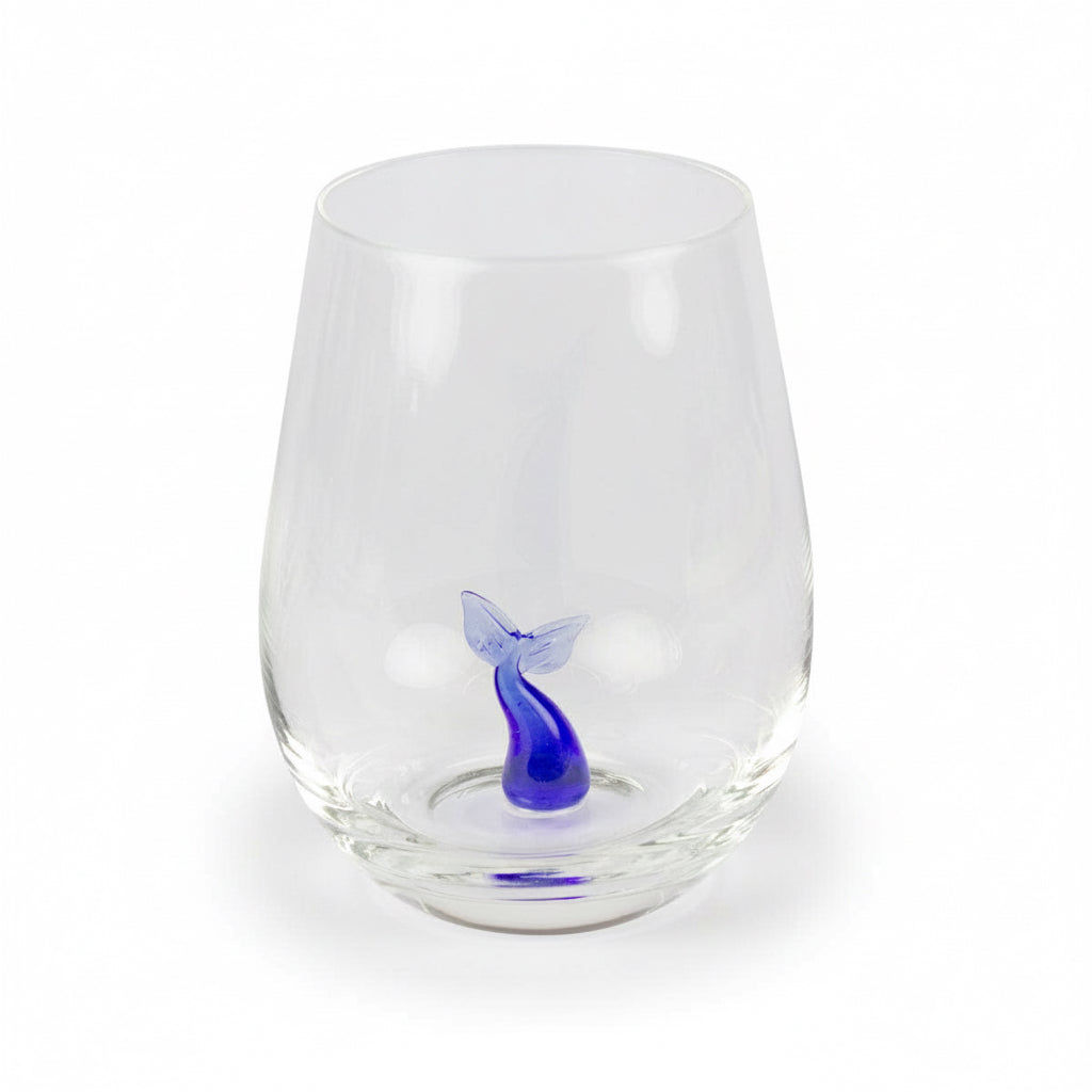 Drinking glass with a small glass whale tail